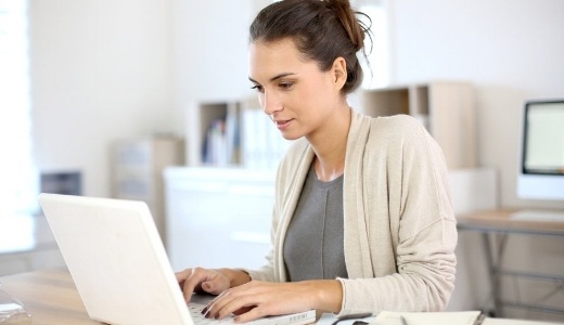 Attractive woman working in office on laptop-535731-edited