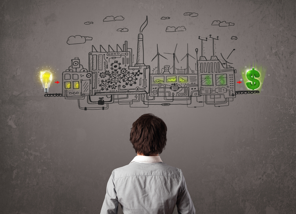 Business man looking at factory that makes money from ideas concept